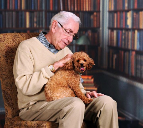 older-man-sitting-in-chair-with-dog