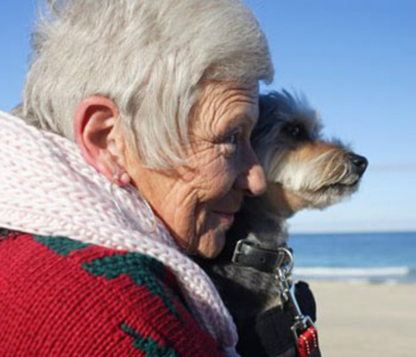 older woman-and-dog beach
