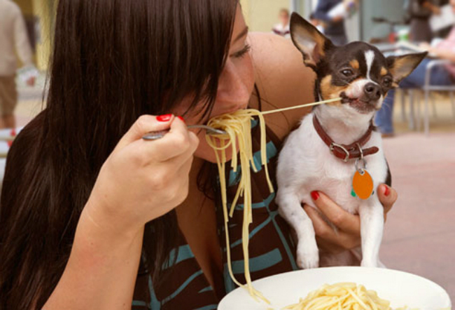 getty_rm_woman_sharing_pasta_with_dog_EDIT