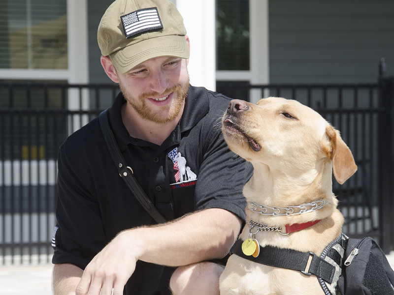 PETER.WILLOTT@STAUGUSTINE.COMNavy reservist Hugh Borchers sits next to his service dog “Guinness” at the K9s for Warriors facility in Nocatee on Wednesday, July 8, 2015. Borchers, who suffers from post-traumatic stress after his service in Afghanistan, was given the dog by K9s for Warriors. The organization pairs service dogs to military veterans suffering from post-traumatic stress, traumatic brain injury or sexual trauma.