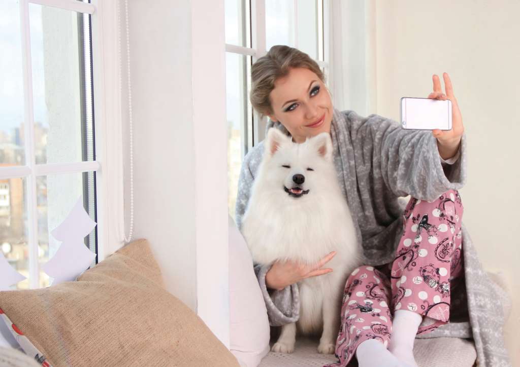 woman taking a selfie with her dog